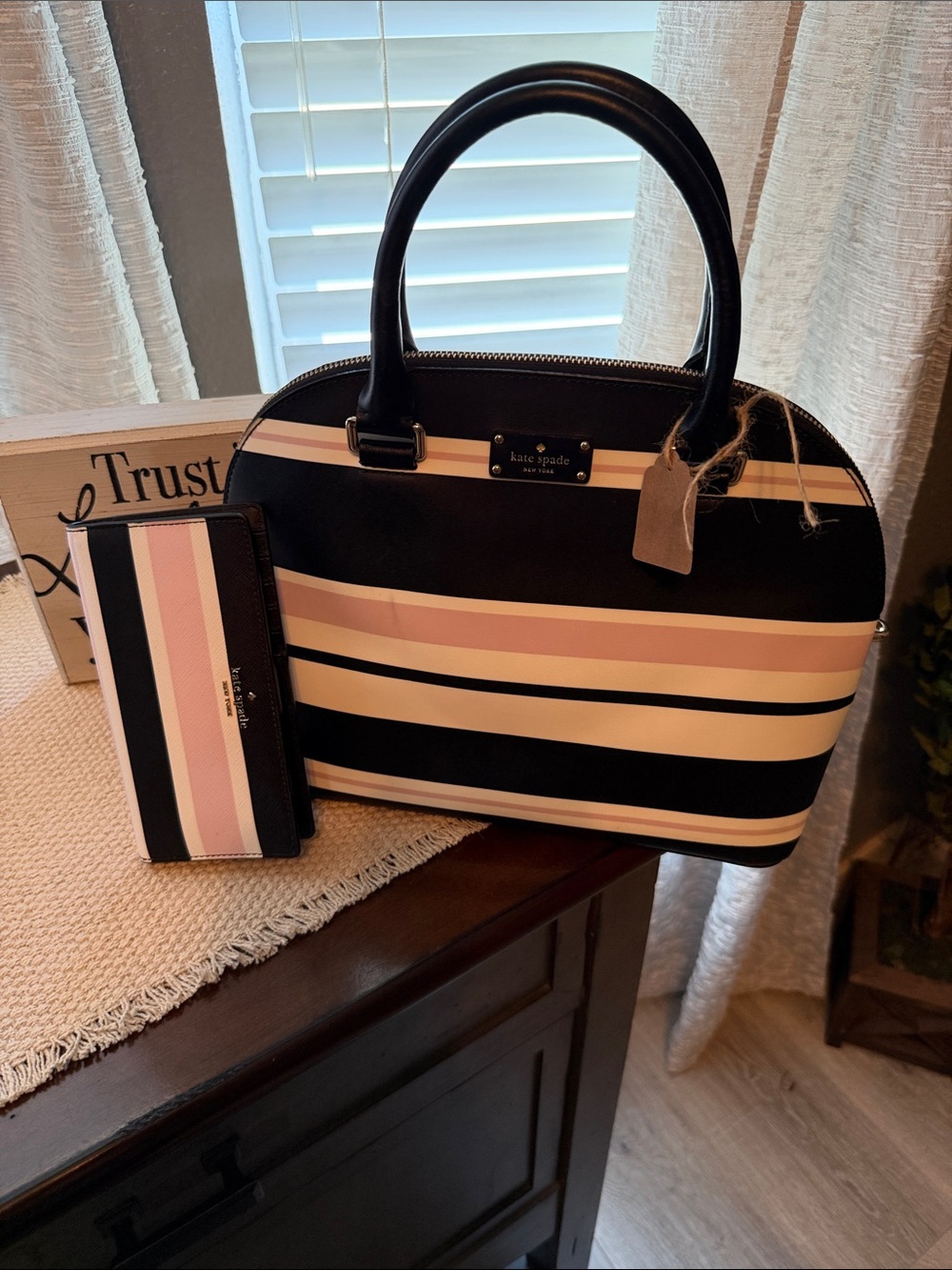 Kate Spade Grove Street Carli Satchel features a classic look